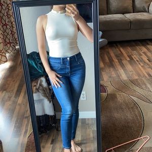 High collar, creme bodysuit.